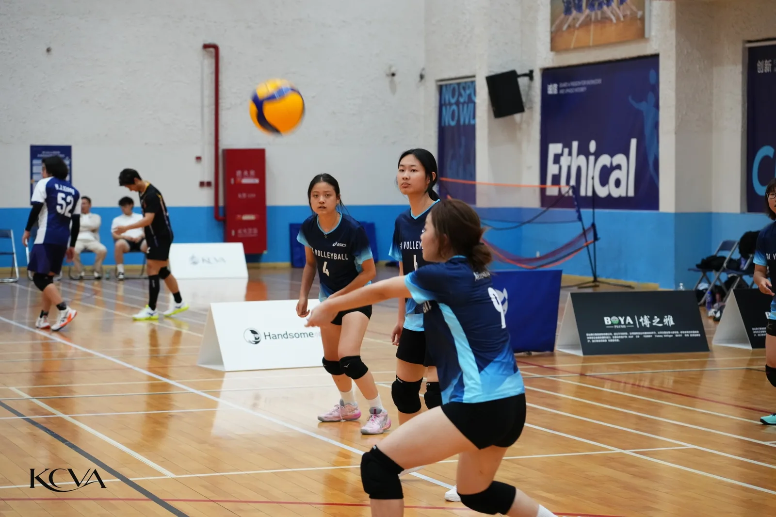 KCVA volleyball players preparing to receive during the KCVA × WLSA tournament